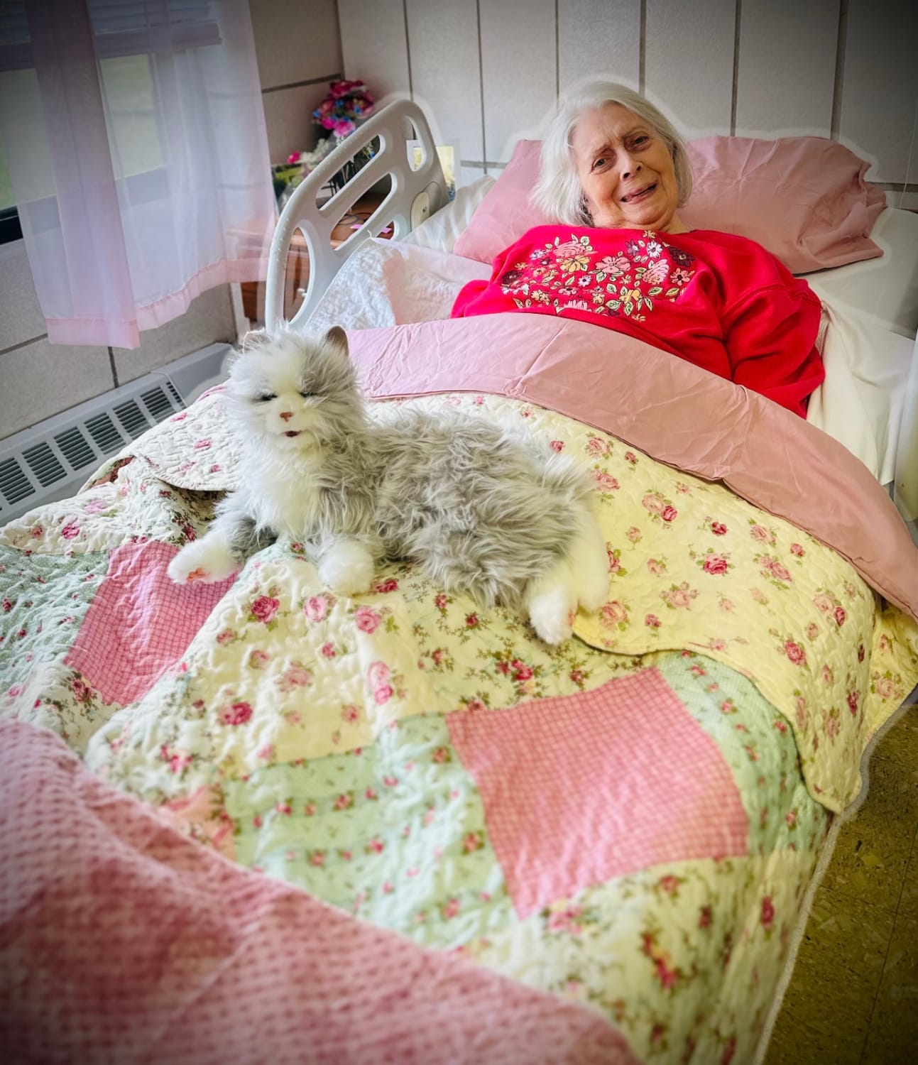 A smiling Perkins Country Manor resident with a companion pet