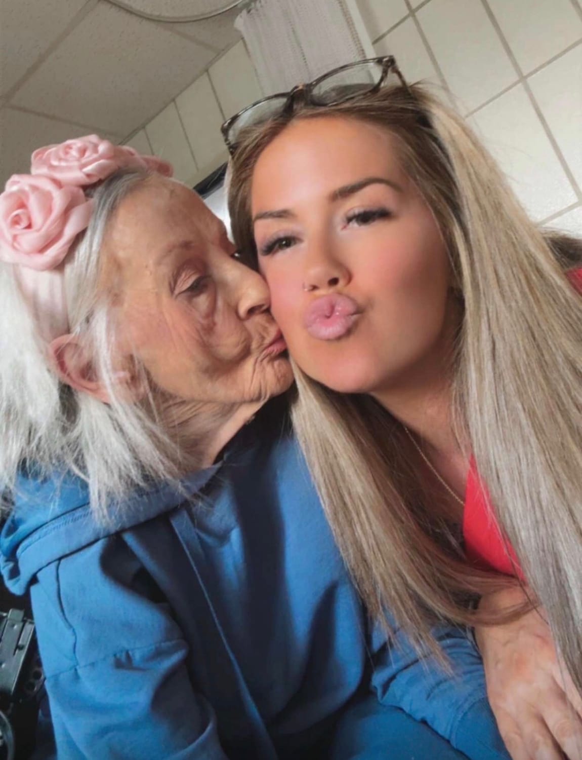 A Perkins Country Manor team member sharing an affectionate moment with a resident